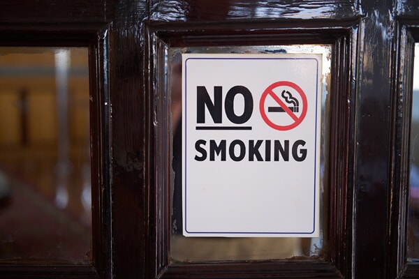 An image of a No Smoking sign on a window.